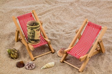 beach chair with piggy bank and dollars clipart