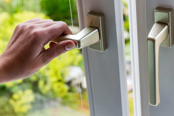 Woman opens window for ventilation — Stock Photo, Image