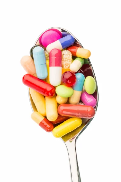 Muitos comprimidos na colher — Fotografia de Stock