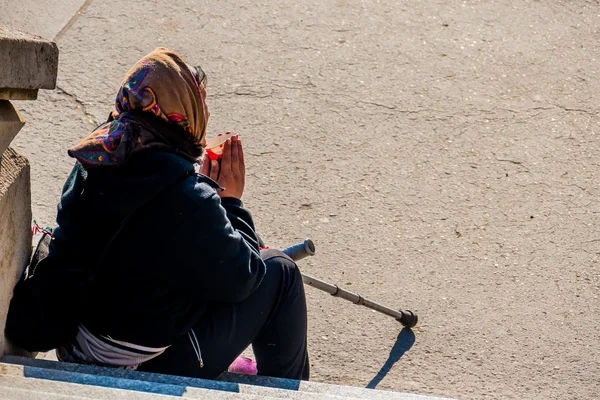Seated beggar — Stock Photo, Image