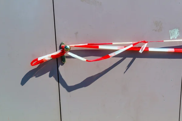 Red-white police tape in front of a door — Stock Photo, Image