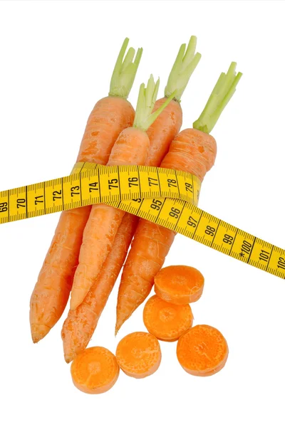 Fresh carrots with tape measure — Stock Photo, Image