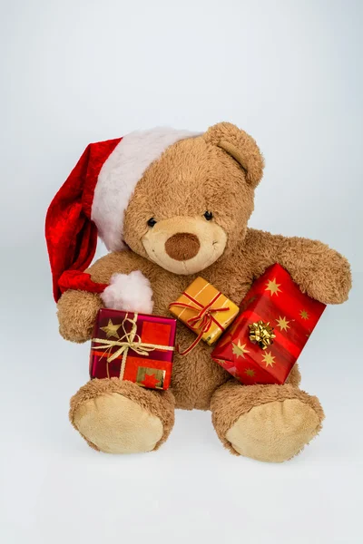 Teddy bear with christmas gifts — Stock Photo, Image