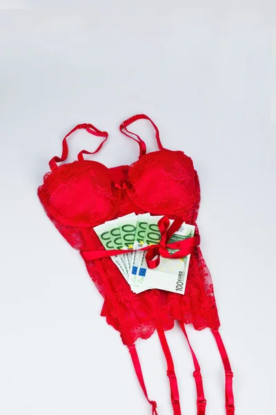 Red lingerie with bills — Stock Photo, Image