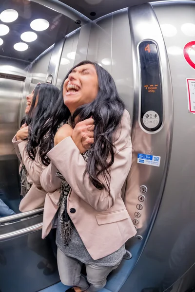 Woman with claustrophobia in elevator — Stock Photo, Image