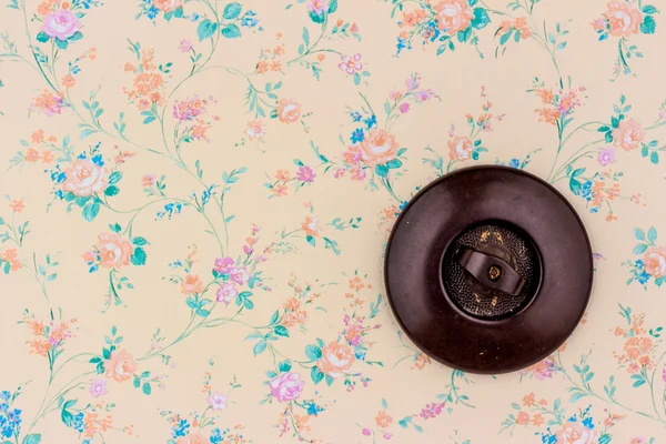 Old wallpaper with light switch — Stock Photo, Image