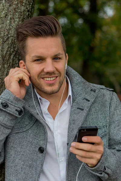 Homem ouve música no celular — Fotografia de Stock