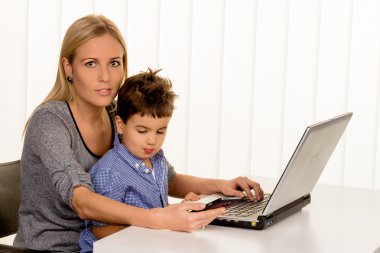mother and son at computer clipart