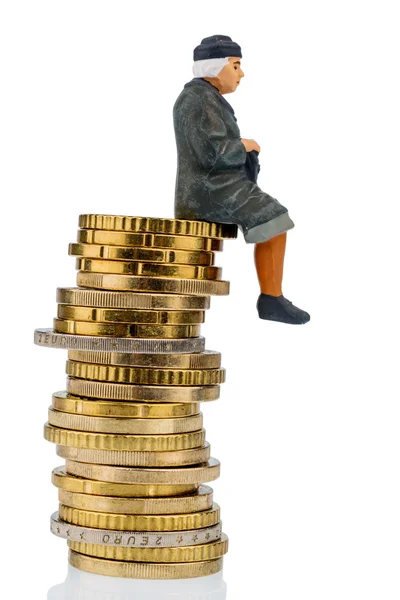 Pensioner sitting on a cash pile — Stock Photo, Image