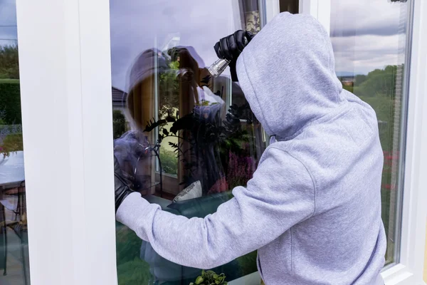 Ladrón en una ventana —  Fotos de Stock