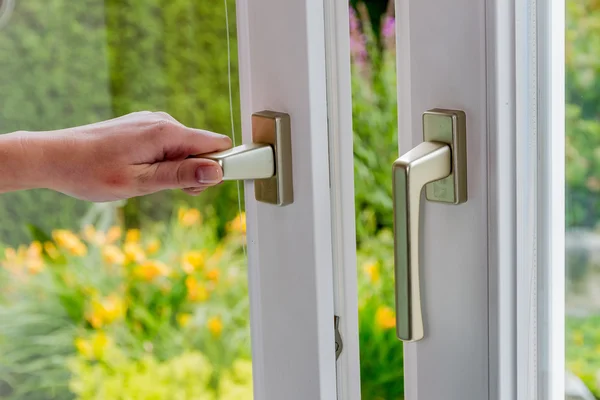 Woman opens window for ventilation — Stock Photo, Image