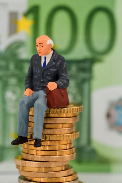 Pensioners sitting on money stack — Stock Photo, Image