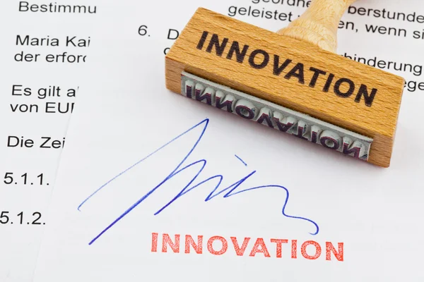 Wooden stamp on the document: innovation — Stock Photo, Image