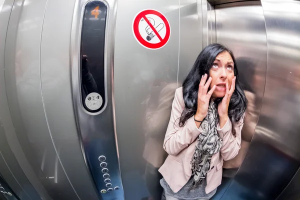 Woman with claustrophobia in elevator — Stock Photo, Image