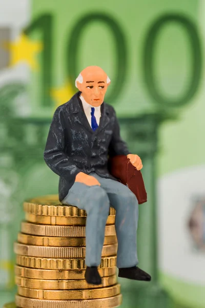 Pensioners sitting on money stack — Stock Photo, Image