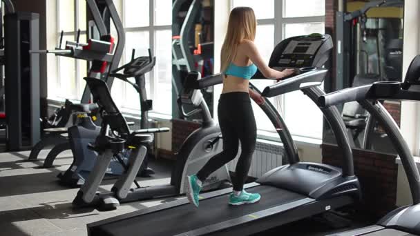 Shot of a girl running on the treadmill — Stock Footage Shot of a girl running on the treadmill Video Clip