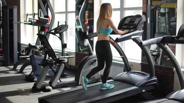 Shot of a girl running on the treadmill — Stock Video