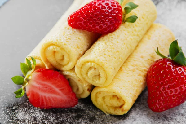 Rolled pancakes with strawberries breakfast Stock Photo