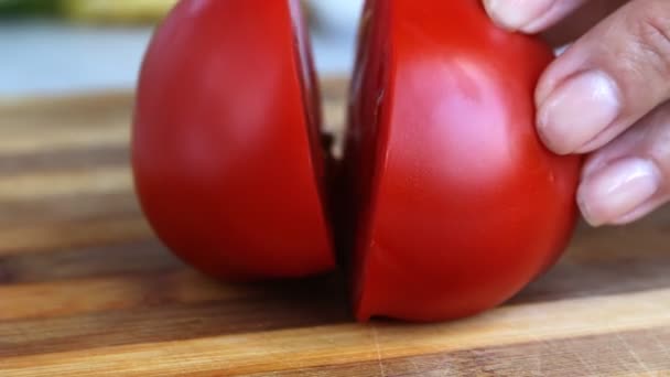 Knife cuts  tomato on the board closeup — Stock Video