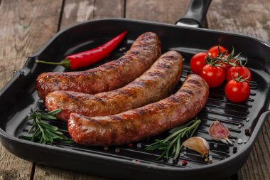Grilled sausages in a pan clipart