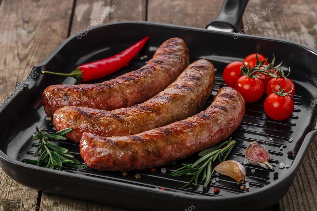 Grilled sausages in a pan — Stock Photo © koss13 58091379