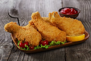 Kızarmış tavuk budu kırıntıları bir ahşap yüzeye