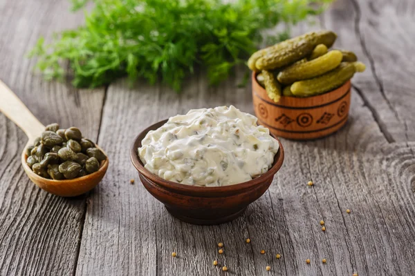 Tartar sauce in a gravy boat on a wooden surface — Stock Photo, Image