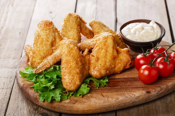 Ali di pollo fritte con salsa e pomodori — Foto Stock