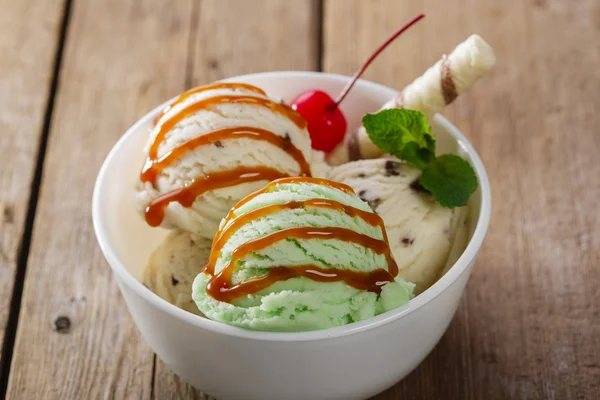 Bola de pistacho y helado blanco en tazón con caramelo — Foto de Stock