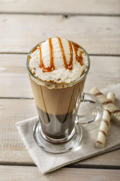 Cold coffee with ice cream and caramel in a glass — Stock Photo, Image
