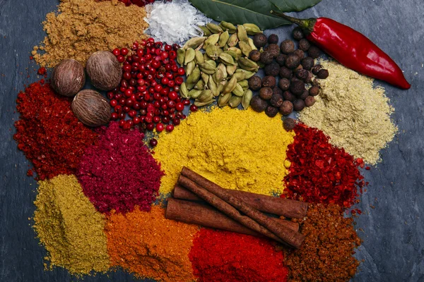 Assortment of spices seasoning on a black stone — Stock Photo, Image