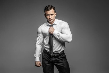 Stüdyoda güçlü ve zarif bir genç adam var.