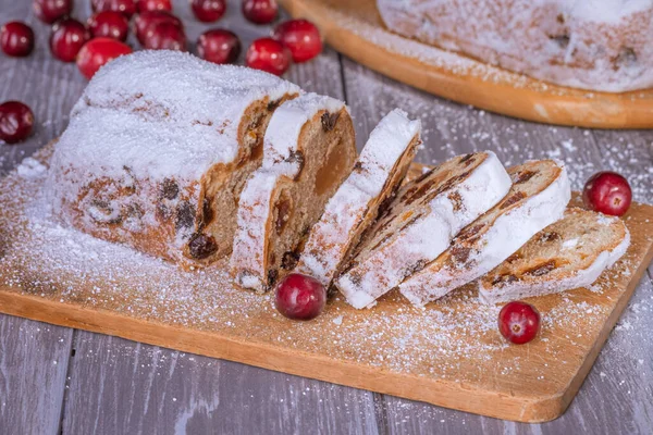 Christmas marzipan stollen cake with icing sugar, marzipan and raisins.