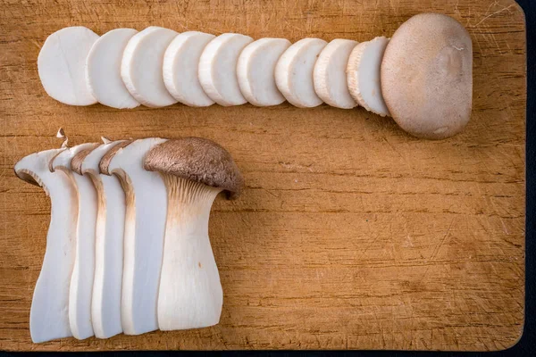 Fresh Raw King Royal Oyster Mushrooms Dark Wooden Table Sliced — Stock Photo, Image