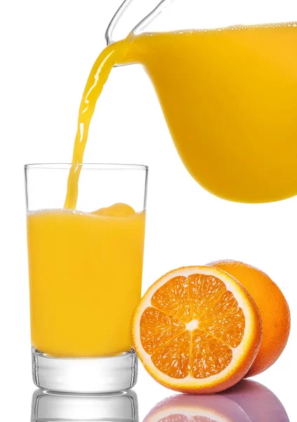 橙汁从水壶中倒入玻璃杯中 在白色背景下隔离 — 图库照片
