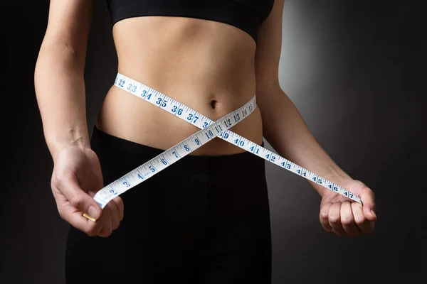 Woman with measure tape — Stock Photo, Image