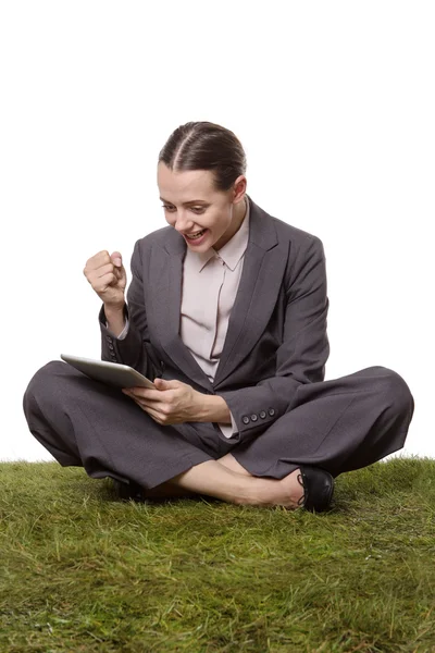 Vieren van succes zittend op het gras — Stockfoto