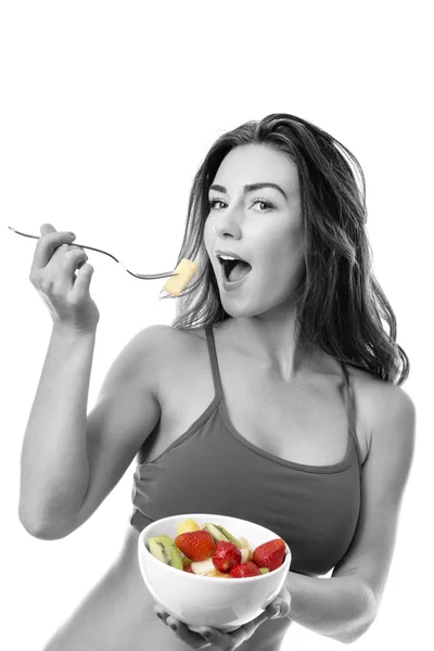 Beautiful brunette eating fruit salad — Stock Photo, Image