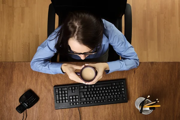 Woman working at desk shot from above — Stock Photo, Image