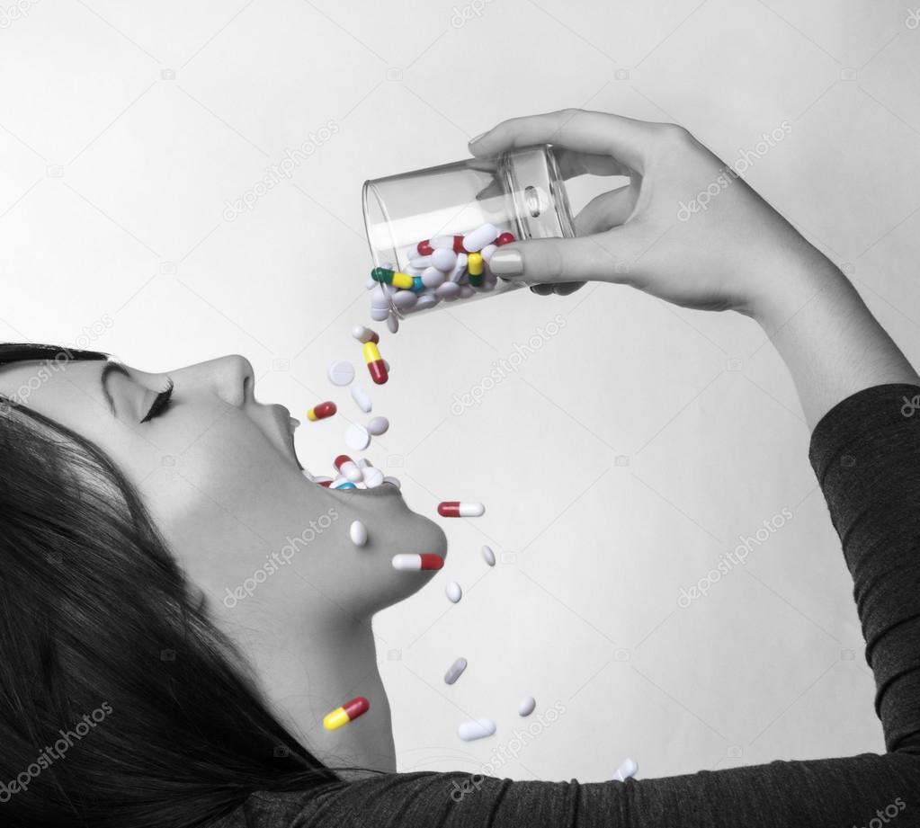 woman drinking pills