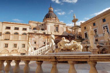 A sunlit European plaza featuring a grand domed building, ornate fountain, and classical statues along a stone balustrade. Timeless elegance and cultural heritage in an architectural plaza.