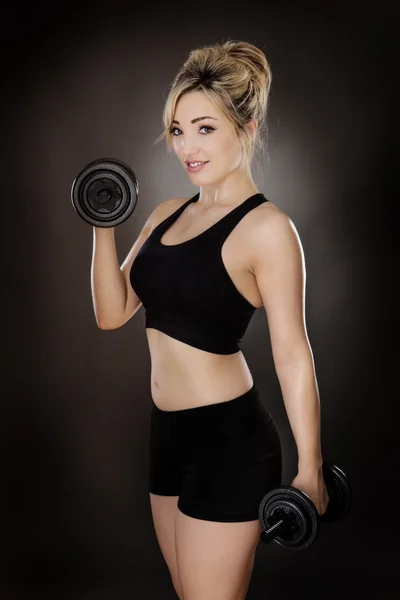 Woman working out using dumbbell — Stock Photo, Image