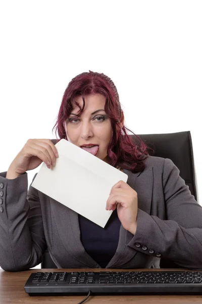 Businesswoman licking envelope — Stock Photo, Image