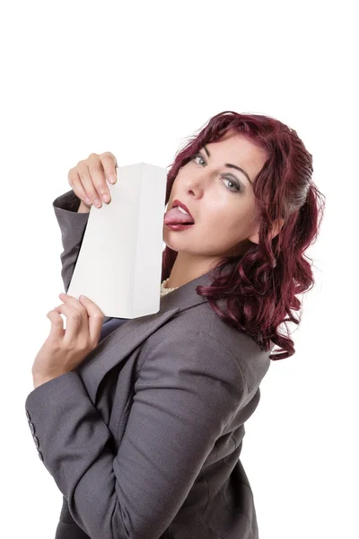 Business woman licking envelope standing up — Stock Photo, Image