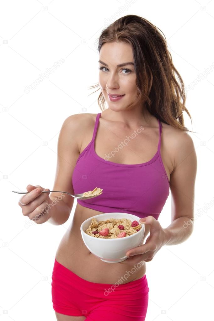 Beautiful brunette eating cereal