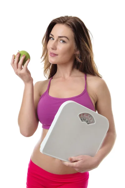 Femme en bonne santé avec une pomme et des écailles . — Photo