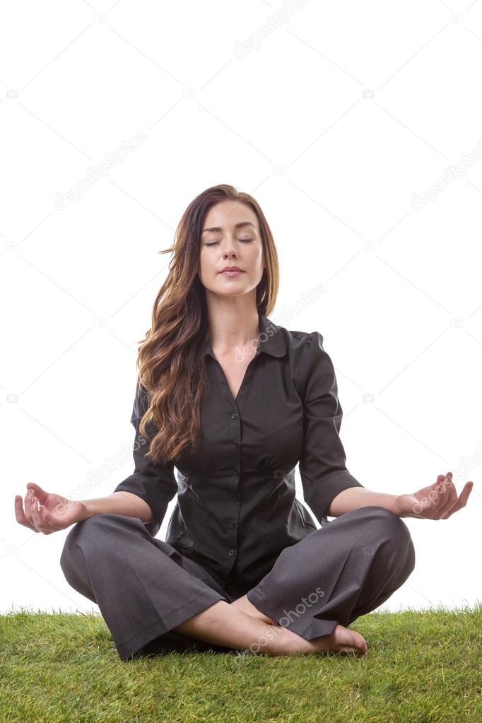 Lovely Caucasian woman sitting cross legged in a yoga pose with her hands  folded in front of her chest Stock Photo - Alamy
