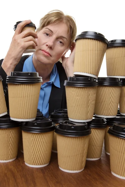 Tired business woman and disposable cups — Stock Photo, Image