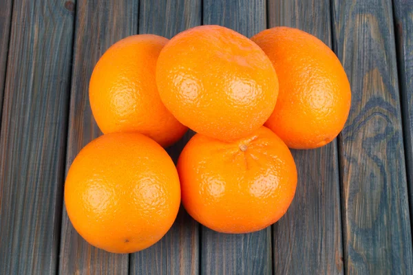 Fresh oranges on a wooden table — Stock Photo, Image