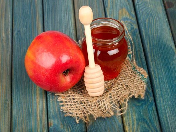 Honey and apple on rustic wooden table — Stock Photo, Image